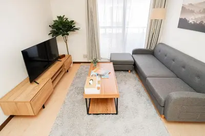 a living room with a couch and a television at GLOU Shibuya House - A Private House in Tokyo Shinjuku & Shibuya Area in Tokyo