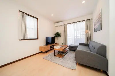 a living room with a couch and a tv at GLOU Shibuya House - A Private House in Tokyo Shinjuku & Shibuya Area in Tokyo