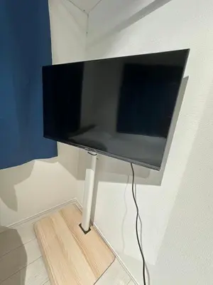 a flat screen tv hanging on a wall at \u65b0\u7bc9OPEN GREW OJI residence101 in Tokyo