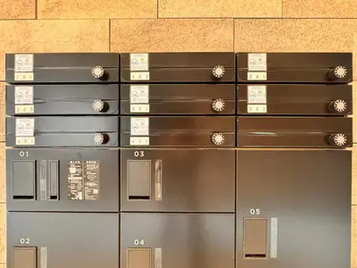 a row of metal lockers in a room at \u65b0\u7bc9OPEN GREW OJI residence102 in Tokyo