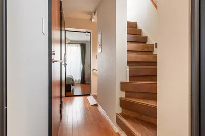 a hallway with a staircase in a house at KIX HOTEL Shinjuku west in Tokyo