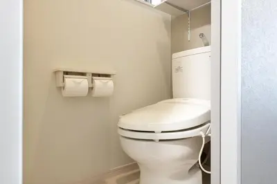 a bathroom with a toilet and two rolls of toilet paper at KIX HOTEL Shinjuku west in Tokyo
