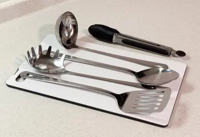 a white cutting board with utensils on a counter at KIX HOTEL Shinjuku west in Tokyo