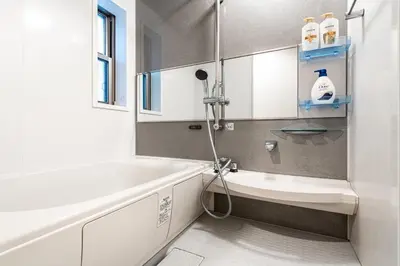 a bathroom with a bath tub and a sink at KIX HOTEL Shinjuku west in Tokyo