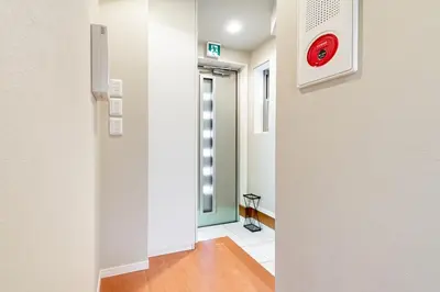 a hallway with a red clock on the wall at KIX HOTEL Shinjuku west in Tokyo