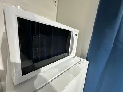 a microwave oven sitting on top of a white cabinet at \u65b0\u7bc9OPEN GREW OJI residence201 in Tokyo