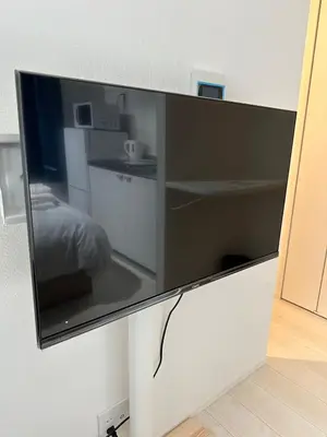 a large flat screen tv hanging on a wall at \u65b0\u7bc9OPEN GREW OJI residence201 in Tokyo