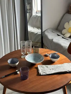 a wooden table with bowls and glasses on it in a living room at l Riverside Shinjuku l in Tokyo
