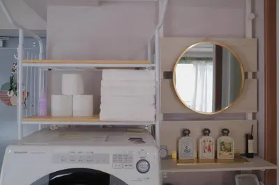a washing machine in a bathroom with a mirror at l Riverside Shinjuku l in Tokyo