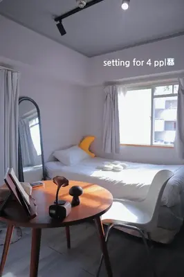 a bedroom with a bed and a table in it at l Riverside Shinjuku l in Tokyo