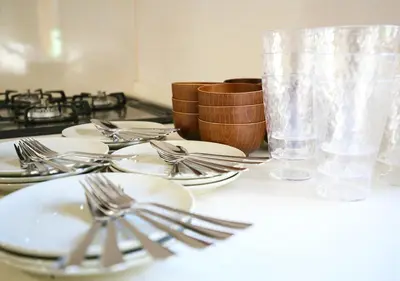 a table with plates and spoons and forks on it at \u6771\u4eac\u90fd\u845b\u98fe\u533a\u306e\u8cb8\u5207\u4e00\u8ed2\u5bb6 in Tokyo