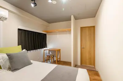 a bedroom with a bed and a desk in it at Good Space Hotel Oshiage in Tokyo