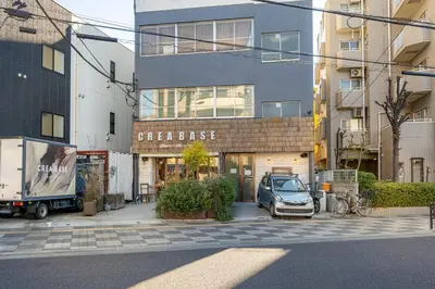 a car parked in a parking lot in front of a building at Good Space Hotel Oshiage in Tokyo