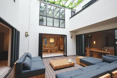 a living room with two blue couches and a table at \u6e0b\u8c37\u672c\u753a\u30db\u30c6\u30eb in Tokyo