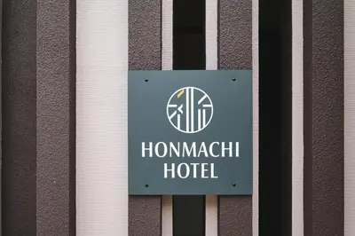 a sign for a hommachi hotel on a building at \u6e0b\u8c37\u672c\u753a\u30db\u30c6\u30eb in Tokyo