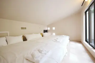 a large white bed in a room with a window at \u6e0b\u8c37\u672c\u753a\u30db\u30c6\u30eb in Tokyo
