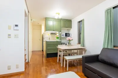 a living room and kitchen with a couch and a table at Shinjuku Newly renovated 4LDK House! in Tokyo
