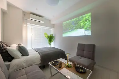 a bedroom with a bed and a couch and a table at LIVCITY Kinshicho 1202 Skytree view in Tokyo