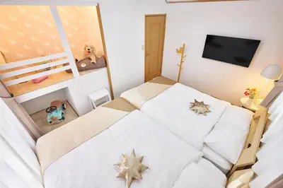 a small bedroom with a bed with stars on the sheets at A 3rooms Max12people 3min Tateishi Sta 20min Asakusa 25min Tokyo Sta 30min Shinjuku Easy Access to Skytree Family House Tokyo \u7acb\u77f3 \u6700\u592712\u540d TATEISHI HIDEAWAY in Tokyo