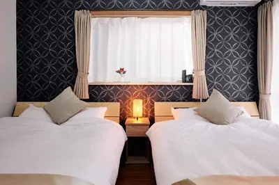 two beds in a room with a window and a window at A 3rooms Max12people 3min Tateishi Sta 20min Asakusa 25min Tokyo Sta 30min Shinjuku Easy Access to Skytree Family House Tokyo \u7acb\u77f3 \u6700\u592712\u540d TATEISHI HIDEAWAY in Tokyo