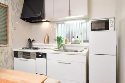 a white kitchen with a sink and a refrigerator at A 3rooms Max12people 3min Tateishi Sta 20min Asakusa 25min Tokyo Sta 30min Shinjuku Easy Access to Skytree Family House Tokyo \u7acb\u77f3 \u6700\u592712\u540d TATEISHI HIDEAWAY in Tokyo