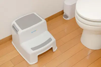 a white litter box next to a toilet in a bathroom at LINKAGE STAY Shinagawa Tachiaigawa in Tokyo