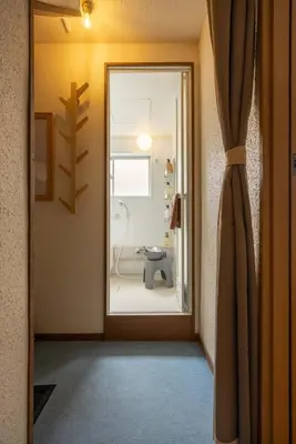a bathroom with a shower through a door at LINKAGE STAY Shinagawa Tachiaigawa in Tokyo
