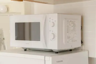 two white microwave ovens sitting on top of a counter at LINKAGE STAY Shinagawa Tachiaigawa in Tokyo