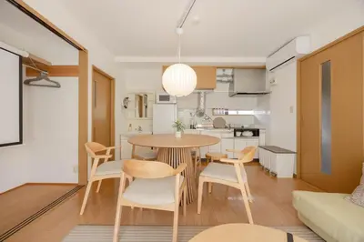 a kitchen and living room with a table and chairs at LINKAGE STAY Shinagawa Tachiaigawa in Tokyo