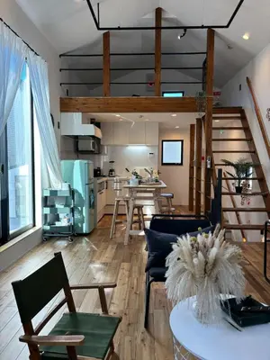 a living room with a table and chairs and a kitchen at Near JR Kameari Tokyo - Shades of Green - Japanese House for up to 6 Guests in Tokyo