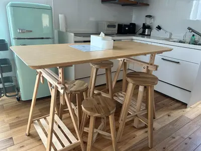 a wooden table in a kitchen with stools at Near JR Kameari Tokyo - Shades of Green - Japanese House for up to 6 Guests in Tokyo