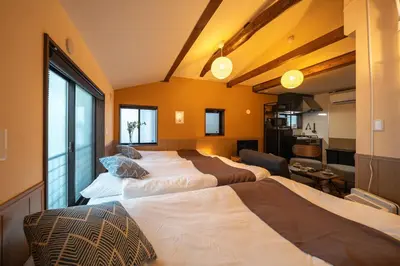 a room with three beds and a kitchen in it at Nestry \u6d45\u8349 yuuan Fuji 202 in Tokyo