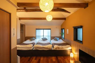 a room with two beds and a television in it at Nestry \u6d45\u8349 yuuan Fuji 202 in Tokyo