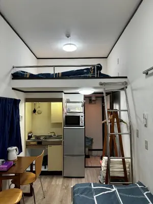 a room with a kitchen and a bunk bed at Miaoyi Shinokubo in Tokyo