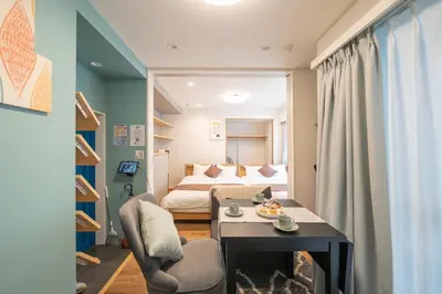 a small room with a bed and a table and chairs at Nestry Asakusa 302\u53f7\u5ba4 in Tokyo