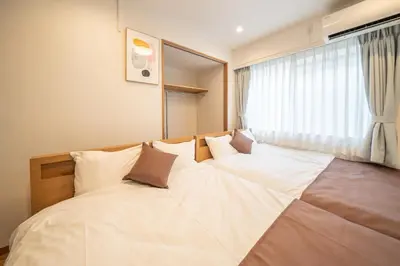 a large white bed in a room with a window at Nestry Asakusa 302\u53f7\u5ba4 in Tokyo