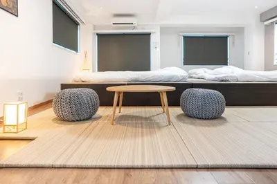 a bed room with a table and two beds at Nestry Asakusa 502\u53f7\u5ba4 in Tokyo