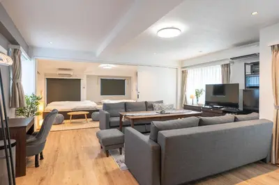a living room with a couch and a table and a bed at Nestry Asakusa 502\u53f7\u5ba4 in Tokyo