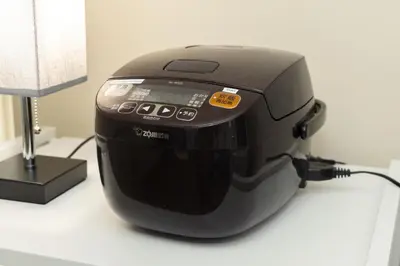 a black toaster sitting on a table next to a lamp at 1200IN&OUT 10people 75m2 8bed! Exclusive house Shinjuku 13 minutes Shibuya 19 minutesIkebukuro 8 minutes Ueno 9 minutes in Tokyo