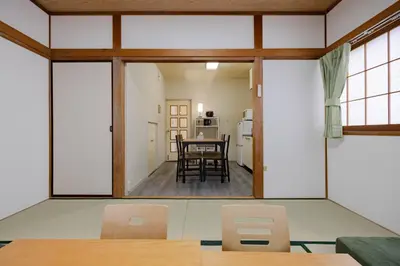 a dining room with a large window and a table at 1200IN&OUT 10people 75m2 8bed! Exclusive house Shinjuku 13 minutes Shibuya 19 minutesIkebukuro 8 minutes Ueno 9 minutes in Tokyo