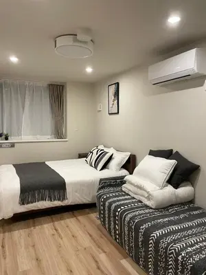 a bedroom with two beds and a window at T-Hotel\u5165\u8c37 in Tokyo