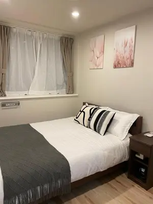 a bedroom with a bed and a window at T-Hotel\u5165\u8c37 in Tokyo