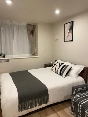 a bedroom with a large bed and a window at T-Hotel\u5165\u8c37 in Tokyo