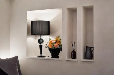 a room with two shelves with flowers and a lamp at shibuya donkey stay in Tokyo