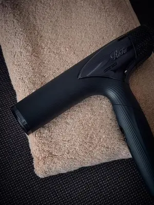 a black brush sitting on top of a carpet at shibuya donkey stay in Tokyo