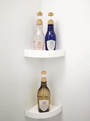 three bottles of vinegar on shelves in a room at shibuya donkey stay in Tokyo
