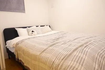 a bed with a stuffed animal sitting on top of it at New Garfieldhome Shinjuku in Tokyo