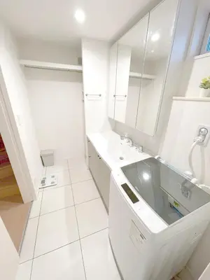 a white bathroom with a sink and a mirror at New Garfieldhome Shinjuku in Tokyo