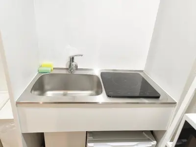 a sink in a small kitchen with a counter top at Z HOME - Self Check in in Tokyo