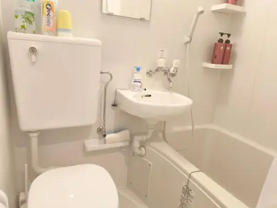 a bathroom with a sink and a toilet and a tub at Z HOME - Self Check in in Tokyo